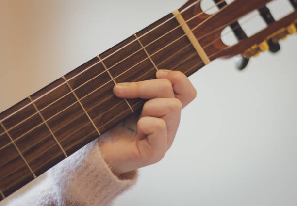 istock Little girl plays the guitar. 1462833073