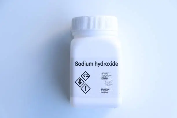 Photo of sodium hydroxide in bottle , chemical in the laboratory and industry