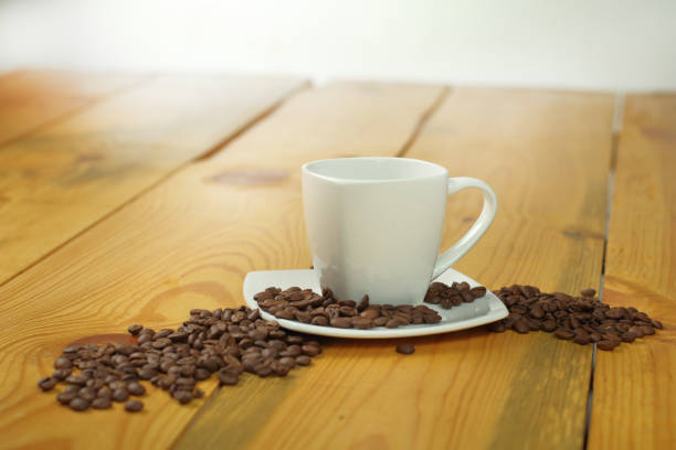 cup of coffee with coffee beans on a wooden table
