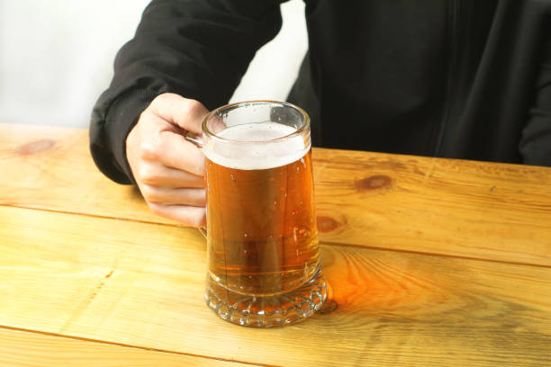 istock person holding a beer mug 1462868804