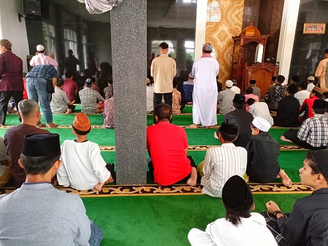 Muslim people doing Friday prayers at the mosque