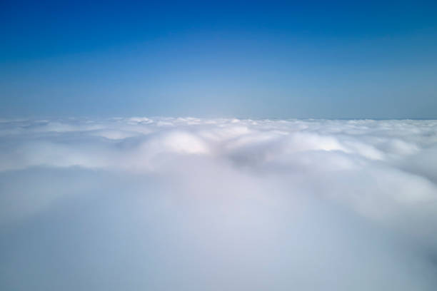 istock Aerial view from high altitude of earth covered with puffy rainy clouds forming before rainstorm 1462899214
