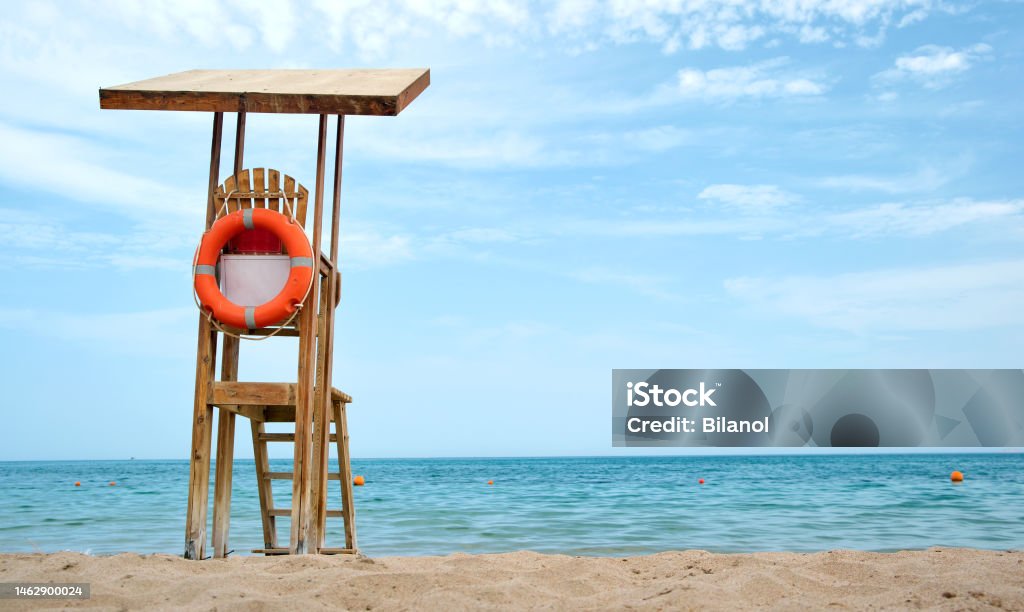 Emplty wooden lifeguard station on sandy beach on ocean shore in summer Emplty wooden lifeguard station on sandy beach on ocean shore in summer. Architecture Stock Photo