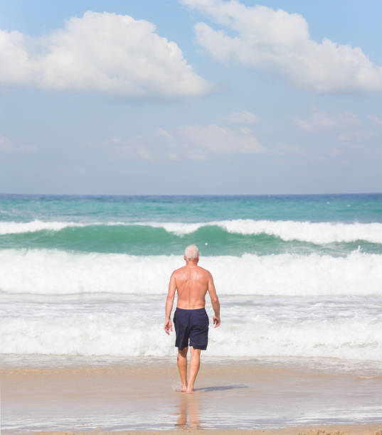 istock A man goes swimming in dangerous big waves 1462902241