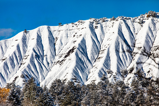 Full frame of of snow covered dramatic mountain landscape. Winter scene in the USA.