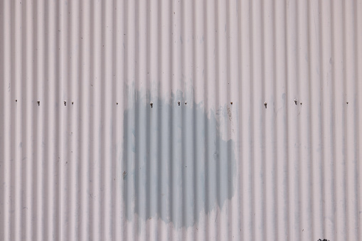 Full frame close-up photo of a corrugated iron fence.