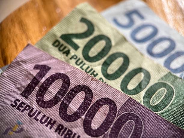 istock Indonesian Rupiah banknotes collection on wood surface 1462908264