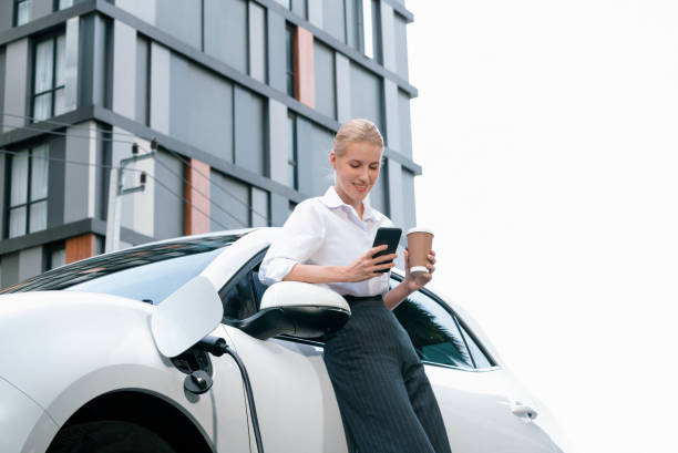 istock Focus progressive woman using phone and holding coffee at charging station. 1462910323