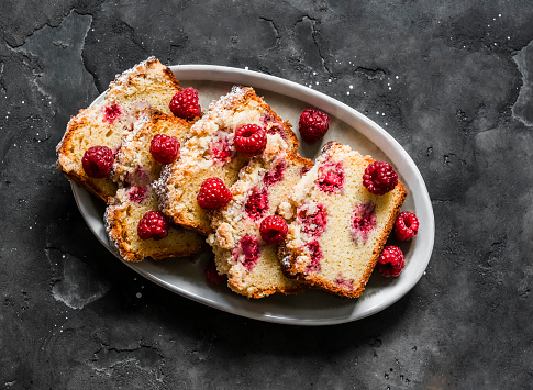 Raspberry cake is a delicious summer dessert on a dark background, top view