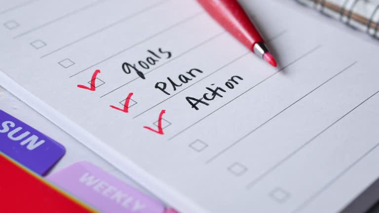 tick mark on planning goals on notepad