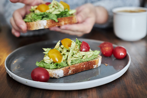 Delicious Brunch Toast, topped with cherry tomatoes, chicken meat and avocado puree