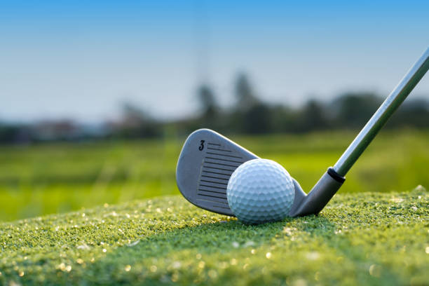 istock Golf balls on the golf course with golf clubs ready for golf in the first short. 1462917649