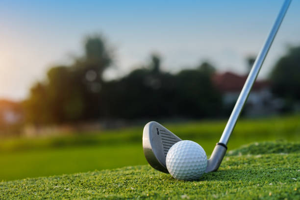 istock Golf balls on the golf course with golf clubs ready for golf in the first short. 1462917663