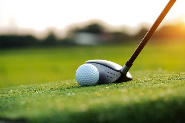 istock Golf balls on the golf course with golf clubs ready for golf in the first short. 1462918242