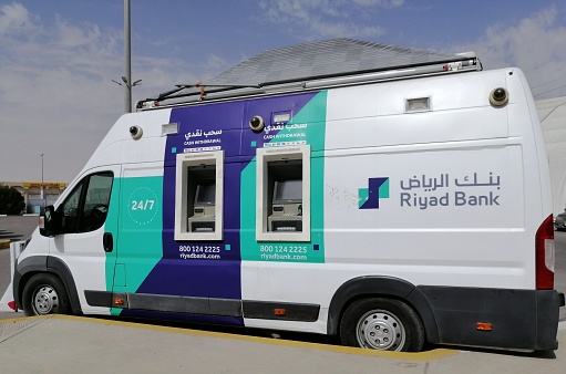 Al Ahsa Saudi Arabia February 2023, Mobile ATM truck parking at public space for service  on a sunny day with blue sky background