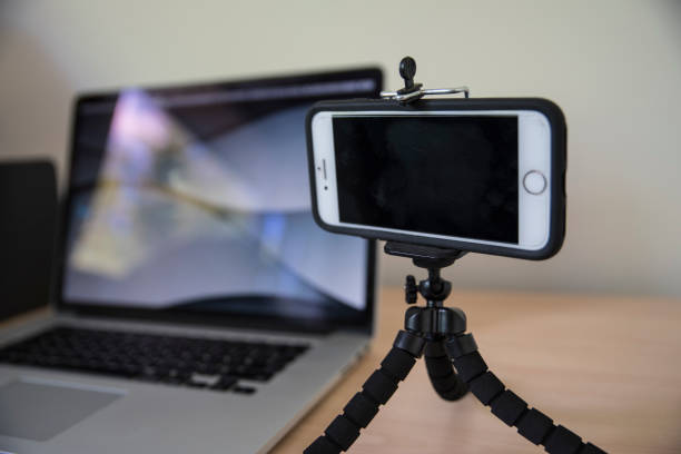 istock Mobile phone on a tripod stand near laptop 1462922461