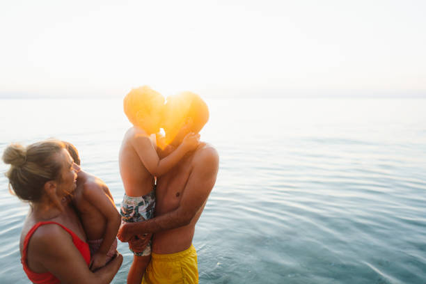 Portrait of a happy family enjoying summer vacation by the sea
