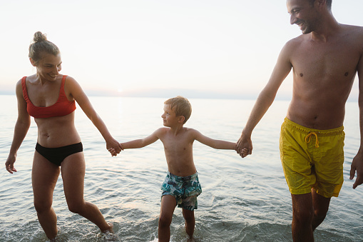 Portrait of a happy family enjoying summer vacation by the sea
