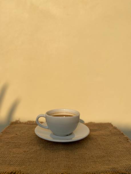 istock Coffee in cup on wooden table in with lighting background 1462925302