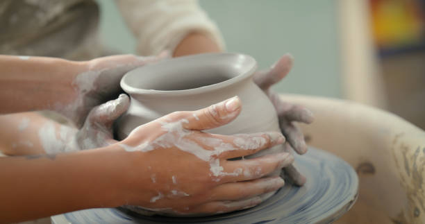 istock Creative class, hands and clay pot with design, product and learning skills in a studio, closeup and sculpture. Startup, pottery and zoom on hand, ceramic molding and hobby for handmade craft or art 1462929423