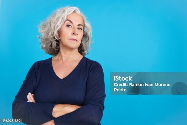 Mature Woman Looking At Camera With A Distrustful Expression Stock Photo - Download Image Now