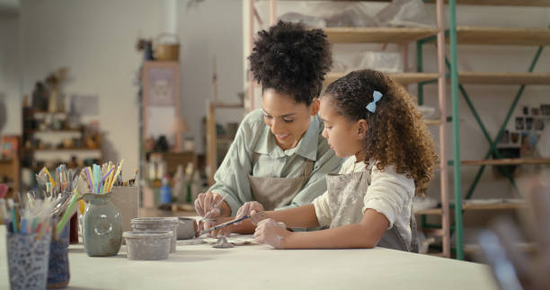 istock Pottery mold, happy mother and girl in studio and ceramic class working with mom. Creative child, learning and sculpture workshop helping a kid with happiness, support and student care together 1462932967