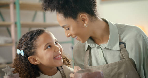 istock Pottery, family mother and child for creative learning, art development and bonding in workshop class together. Creativity, craft or sculpture black woman, mom or person with kid for education fun 1462932979