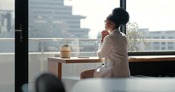 Window, business and black woman thinking, opportunity and decisions in modern office, relax and calm. View, African American female employee and leader on break, vision and ideas for new project