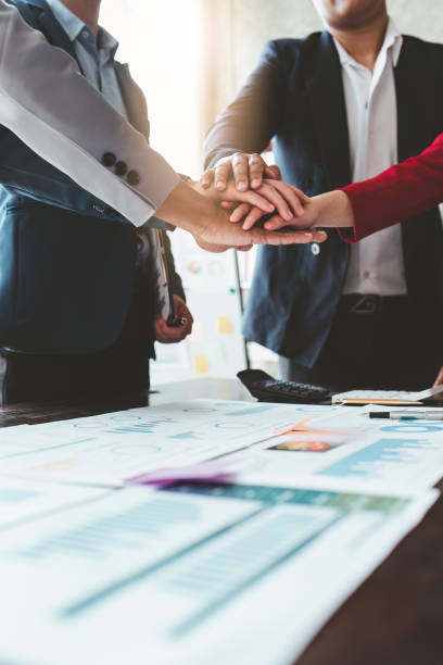 Close up Asian Business people stack of hands working together. Teamwork, Unity, business team concept