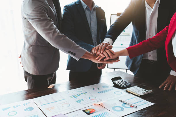 istock Close up Asian Business people stack of hands working together. Teamwork, Unity, business team concept 1462935173