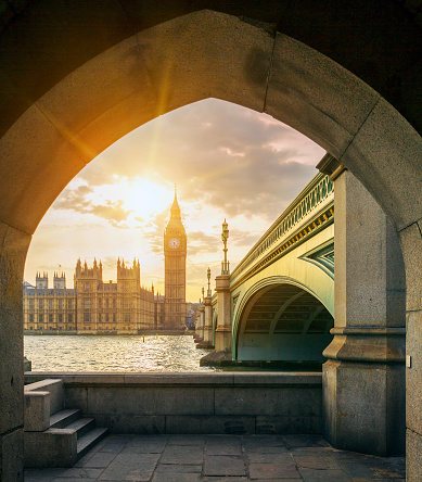 View of Big Ben and sun  through the pedestrian tunnel at sunset, London.