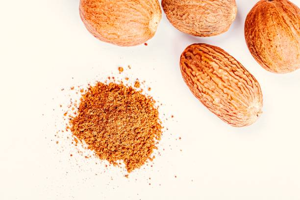istock Nutmeg and ground nutmeg on white background, top view 1462936581