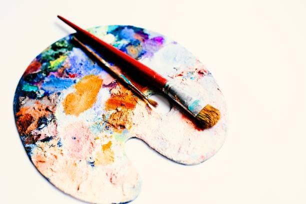 istock Painter's palette with oil paint and brushes on white background 1462938246