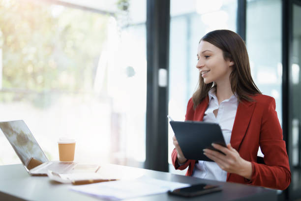 istock business owner or Asian female marketers are using tablet computer in office work 1462938311