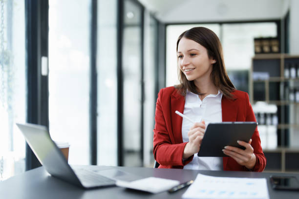 istock business owner or Asian female marketers are using tablet computer in office work 1462938345