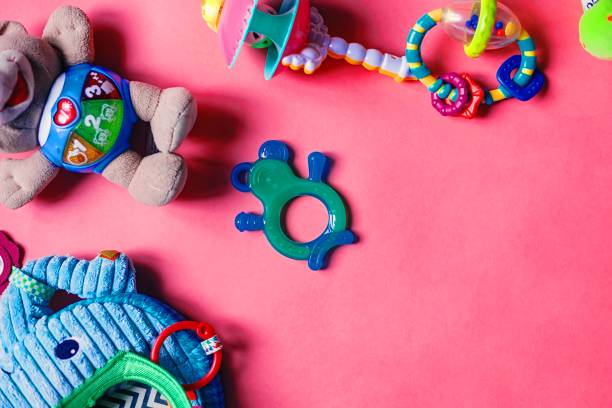 istock Newborn kid rattle set on the pink background. Copy space for text. 1462938629