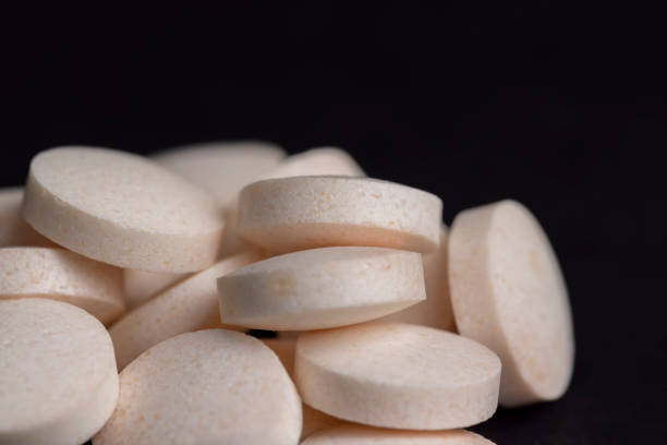 istock White and yellow medical medicines on a black background 1462938738