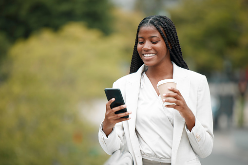Coffee, social media and black woman with a phone in a park for 5g communication, email and mobile app in Argentina. Business, reading and employee with a mobile for a chat and tea on a nature walk