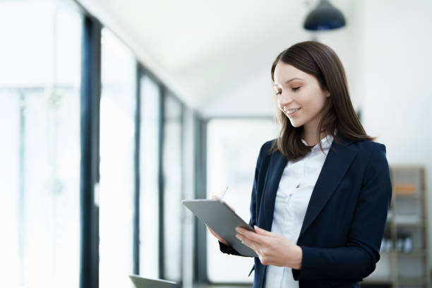 istock business owner or Asian female marketers are using tablet computer in office work 1462940553