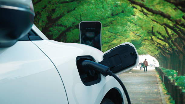 istock Progressive EV car recharging battery at the park surround with people and tree. 1462942928