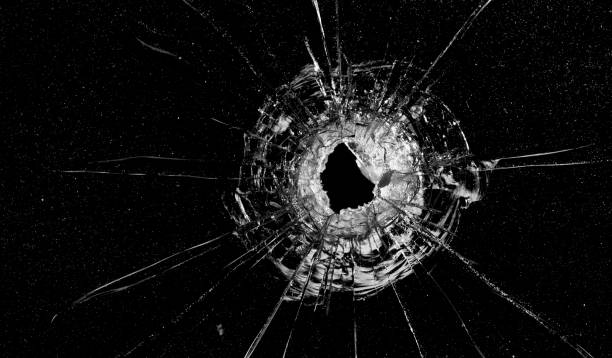 istock A bullet hole in the glass on a black background 1462948118