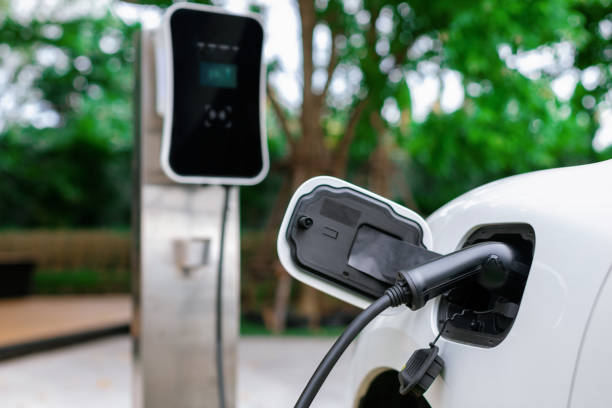 istock Focus closeup EV car and charger with blur background for progressive concept 1462948402