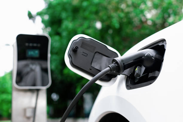 istock Focus closeup EV car and charger with blur background for progressive concept 1462949138