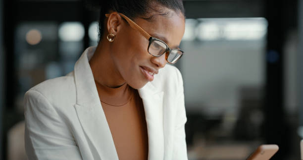 istock Corporate face, search or black woman with phone for communication, reading email or networking in office building. Digital, tech or girl on smartphone for social media, website or internet in office 1462950387