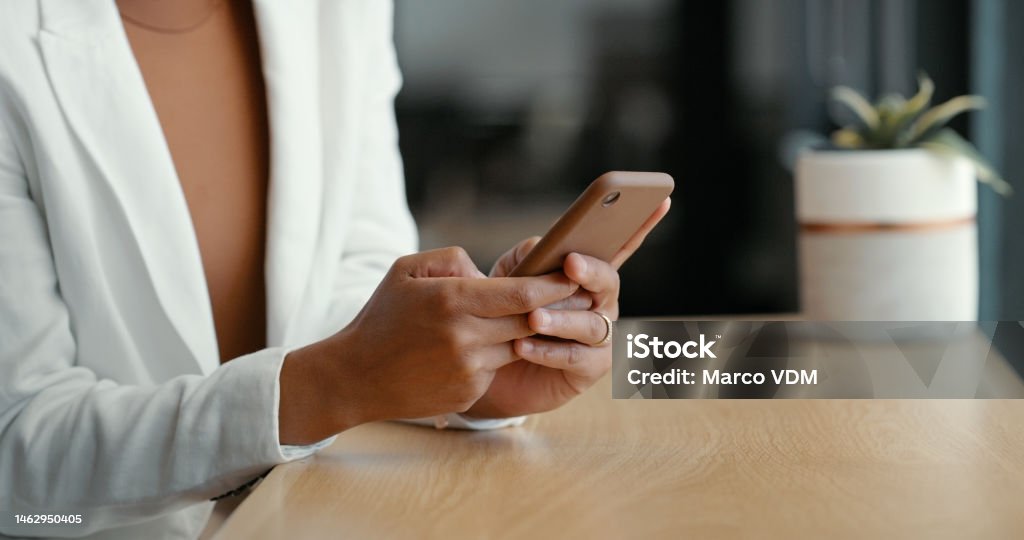 Corporate, social network or black woman hand on phone for communication, reading email or networking in office building. Digital, tech or girl on smartphone for research, website or internet search 5G Stock Photo