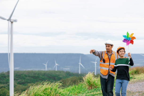 istock Progressive engineer with his son holding windmill toy in the mountain. 1462951123
