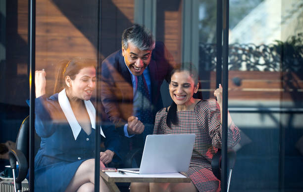 istock Business people celebrating online success using laptop 1462956594