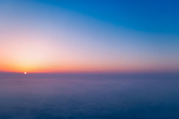 A wonderful bright dawn, above the clouds. Drone flight over the dawn.