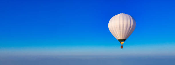 istock White balloon on the background of the blue sky panorama. 1462956690