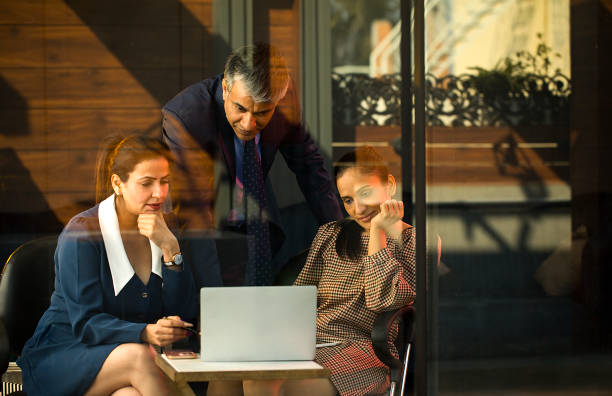 istock Business people discussing using laptop at office 1462956724